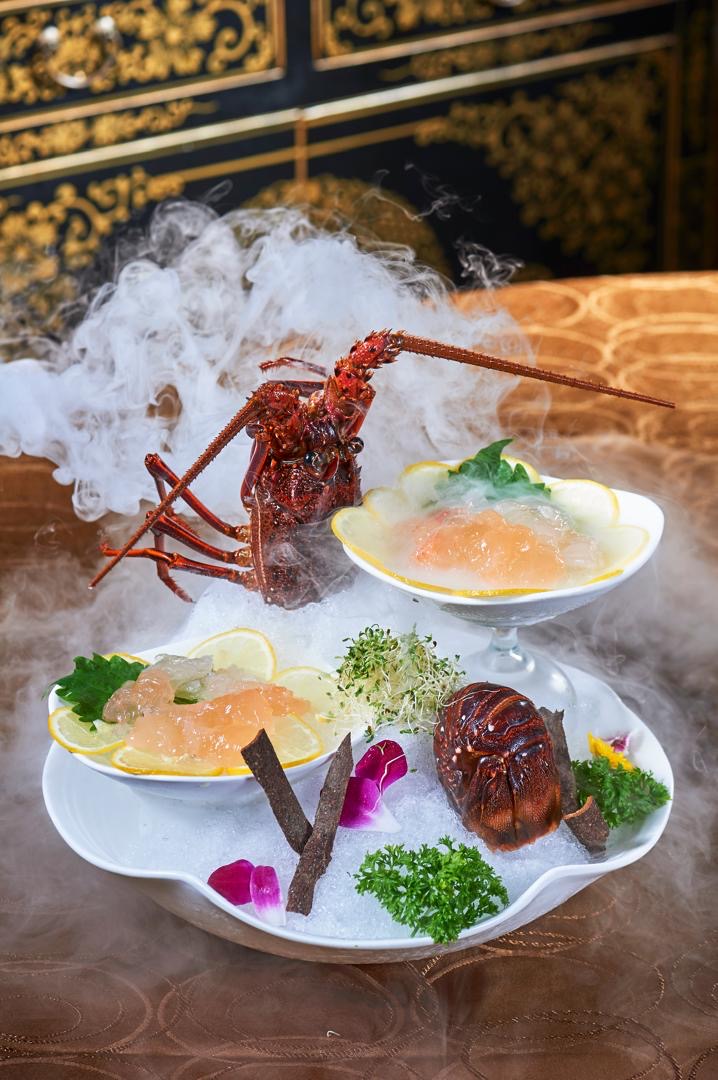 Live lobster sashimi on a smoking ice platter
