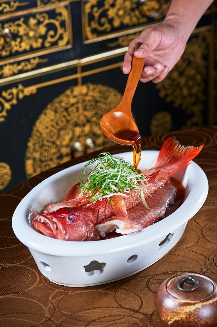 Steamed red snapper with house soy sauce poured tableside